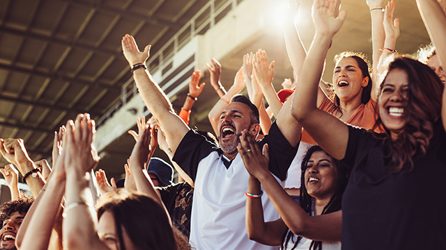 group of people celebrating at a sporting event